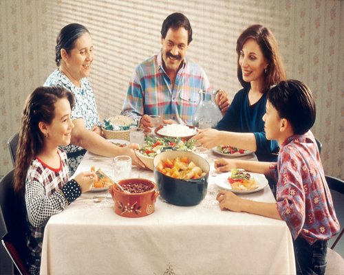 family sharing dinner at home